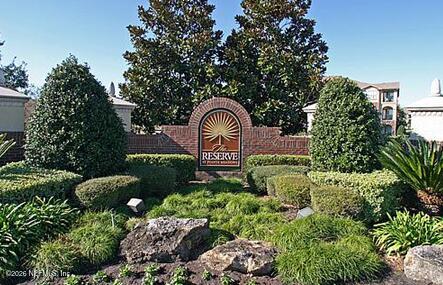 7800 Point Meadows Drive, Unit 835 Jacksonville, FL 32256 - Photo 13 of 13 a view of a garden with plants and large trees