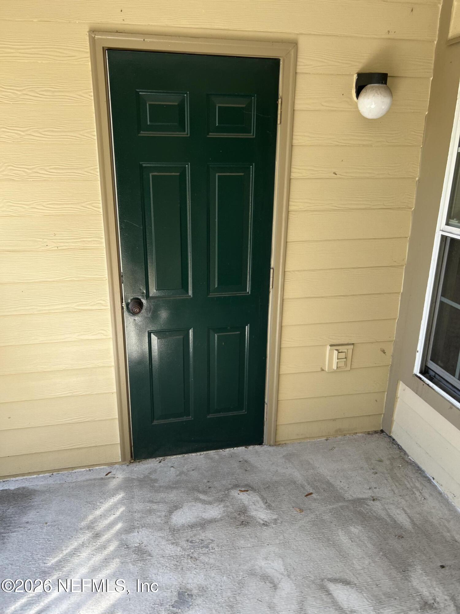 7800 Point Meadows Drive, Unit 835 Jacksonville, FL 32256 - Photo 3 of 13 a view of a house with a door and wooden door