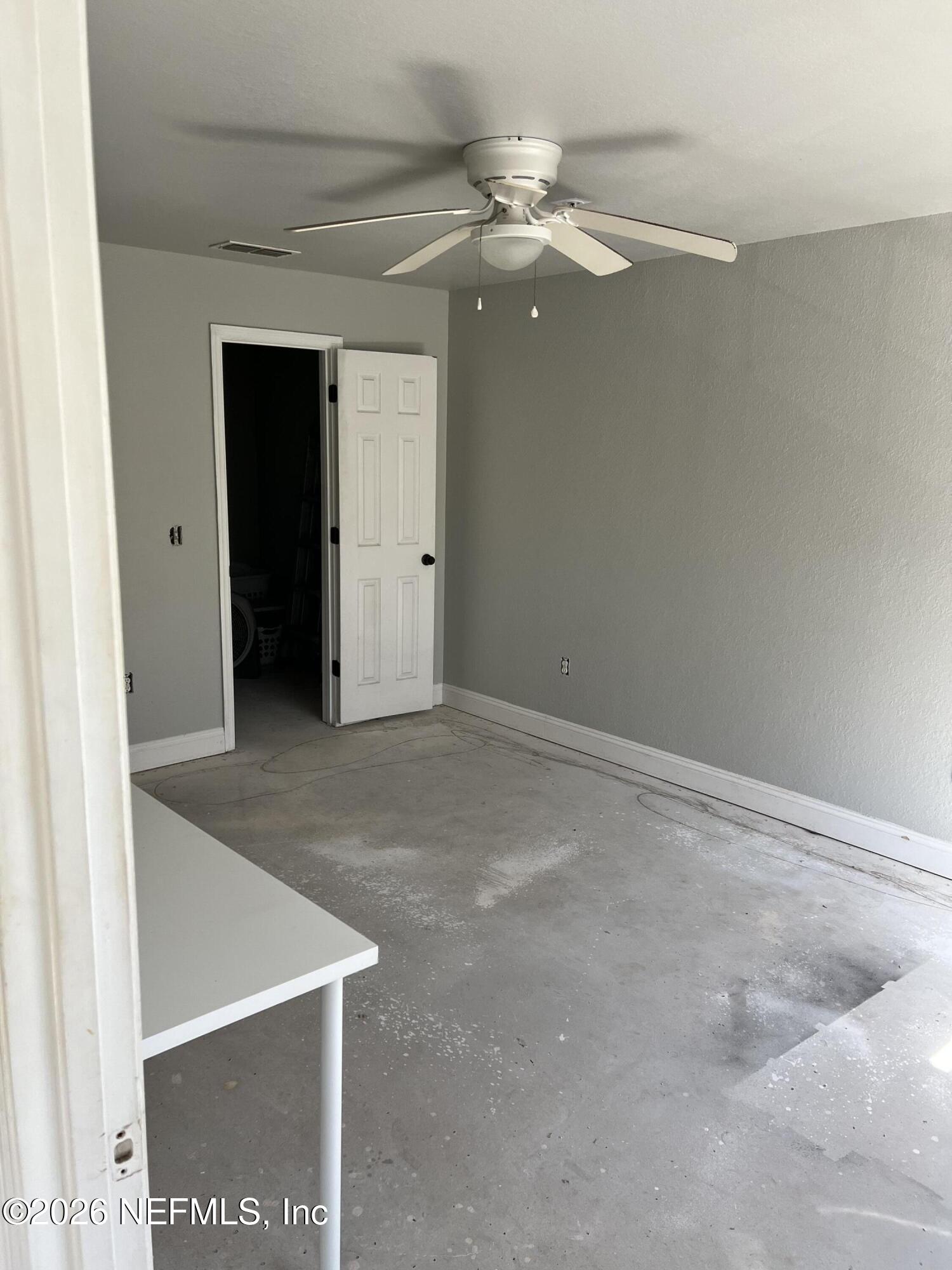 7800 Point Meadows Drive, Unit 835 Jacksonville, FL 32256 - Photo 8 of 13 a view of an empty room with window and a chandelier fan