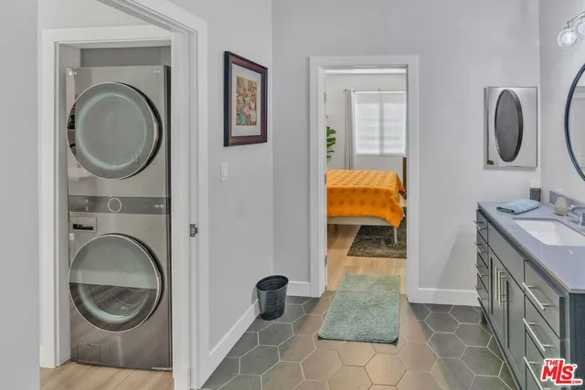 a bathroom with a granite countertop sink a mirror and vanity