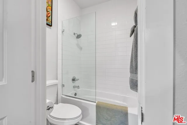 a bathroom with a toilet a sink and shower