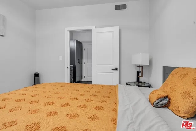 a bedroom with a bed and a lamp