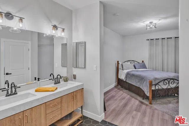 a bathroom with a double vanity sink and a mirror