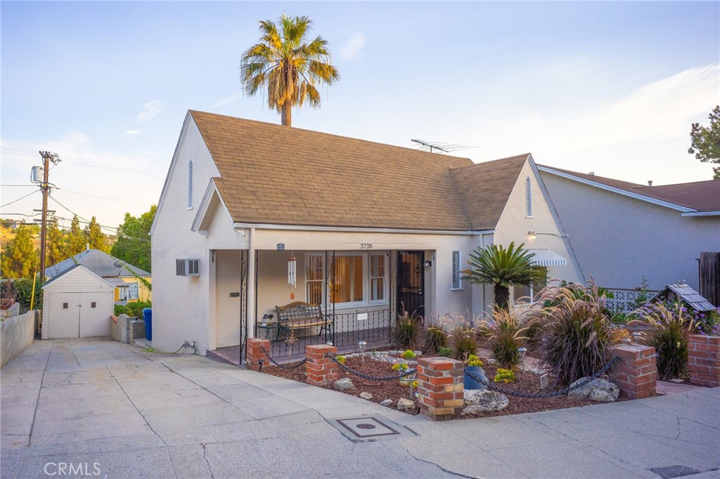 a view of house with outdoor space and sitting area