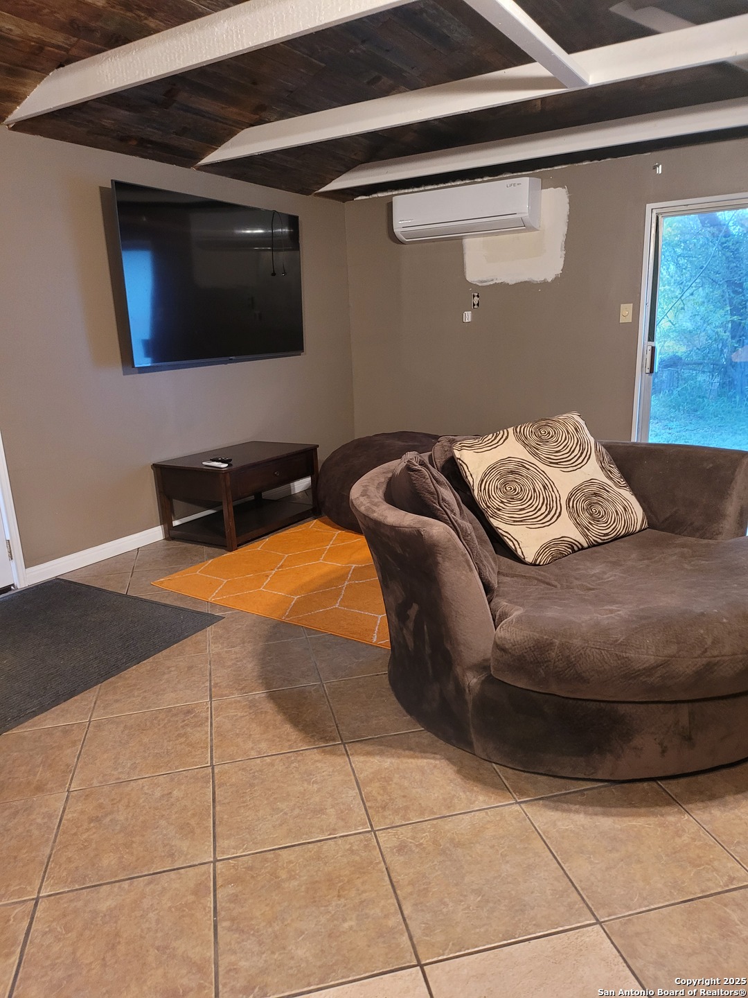 11489 South Foster Road San Antonio, TX 78223 - Photo 5 of 7 a bedroom with a bed and a flat screen tv