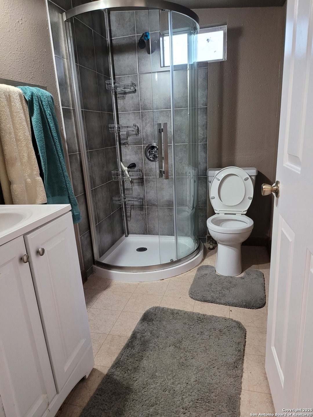 11489 South Foster Road San Antonio, TX 78223 - Photo 6 of 7 a bathroom with a sink and a mirror