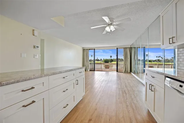 a view of a kitchen with wooden floor and electronic appliances
