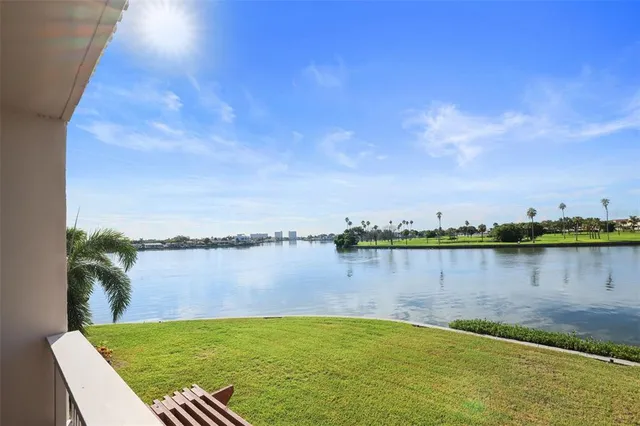 a view of a lake with houses in the back