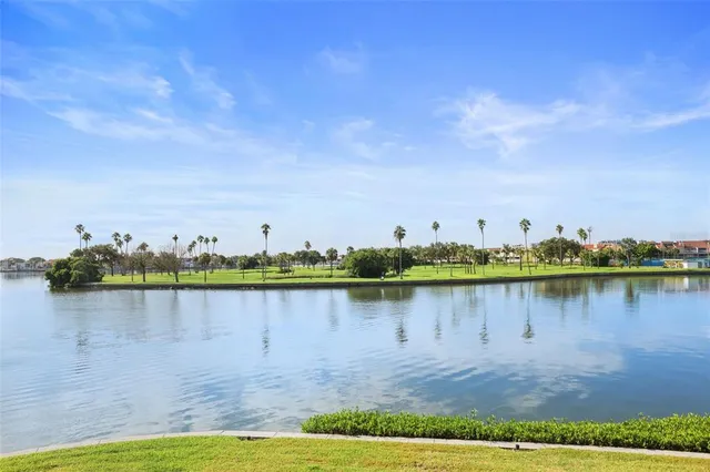 a view of a lake with houses in the background