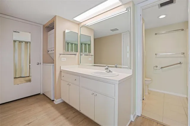 a bathroom with a sink a mirror and a shower