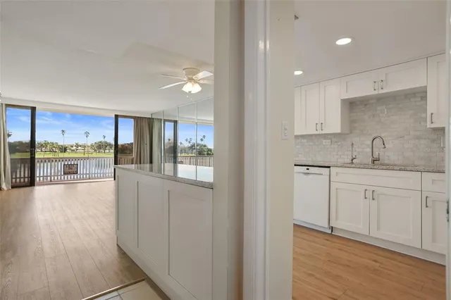 a view of a kitchen with a sink and wooden floor