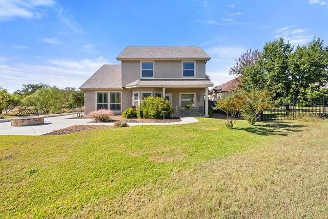 a front view of a house with swimming pool having outdoor seating