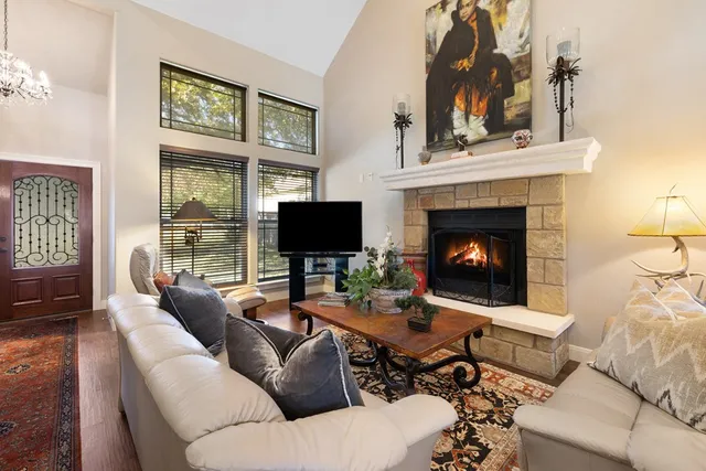 a living room with furniture a fireplace and a flat screen tv