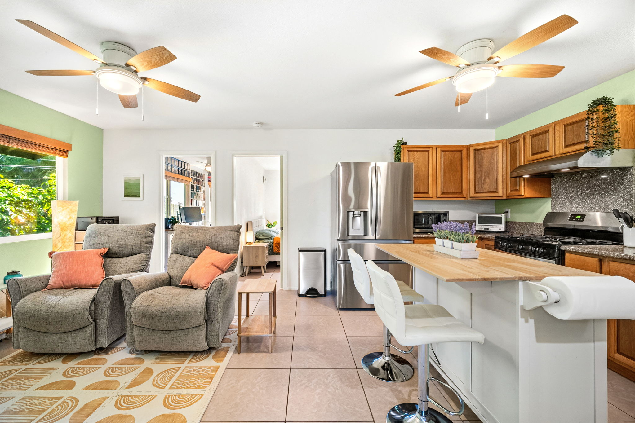 6250 Olohena Road, Unit 2 Kapaa, HI 96746 - Photo 1 of 29 a large kitchen with stainless steel appliances lots of counter space and a chandelier