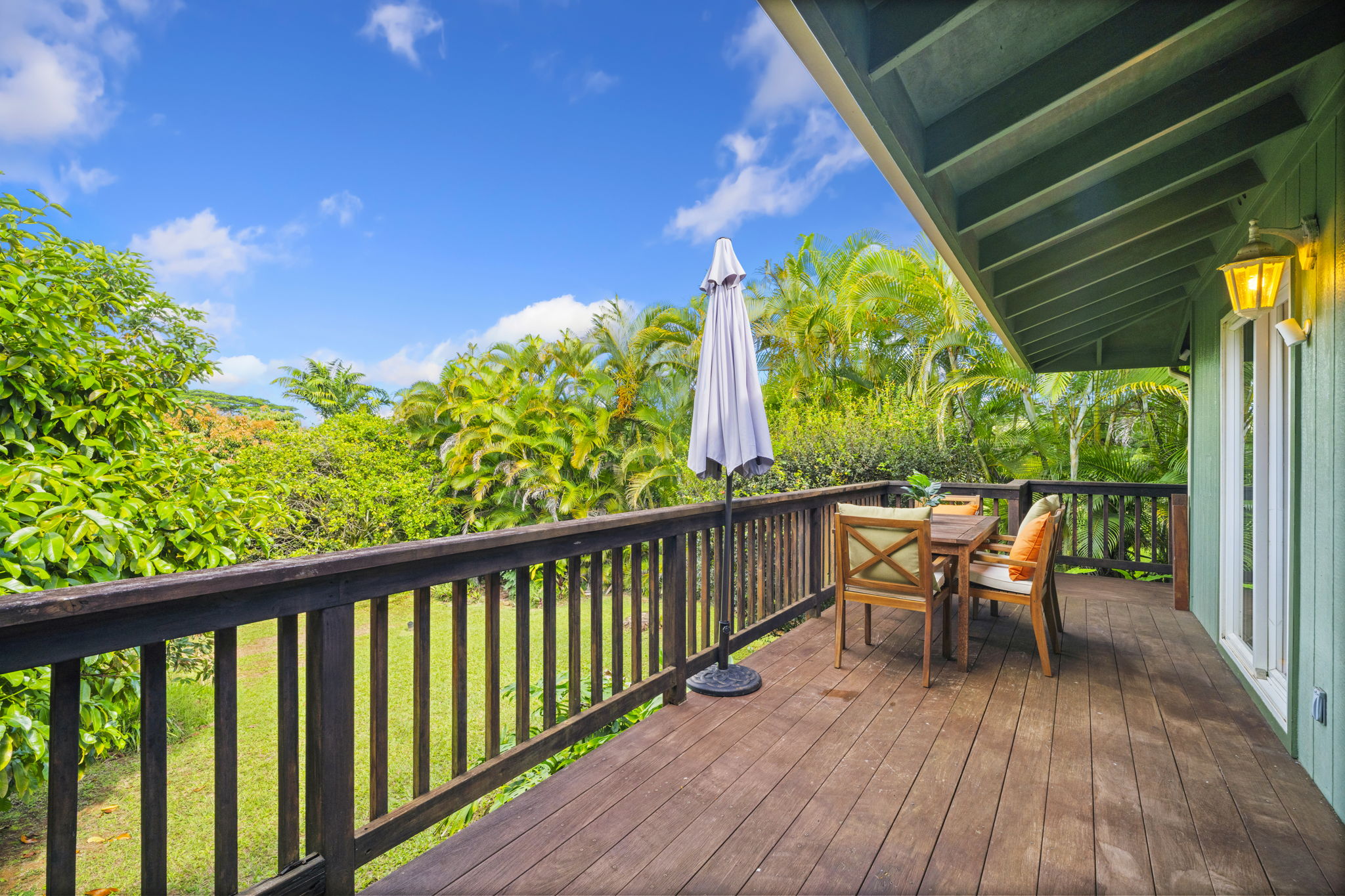 6250 Olohena Road, Unit 2 Kapaa, HI 96746 - Photo 18 of 29 a view of a chairs and table in patio with wooden fence