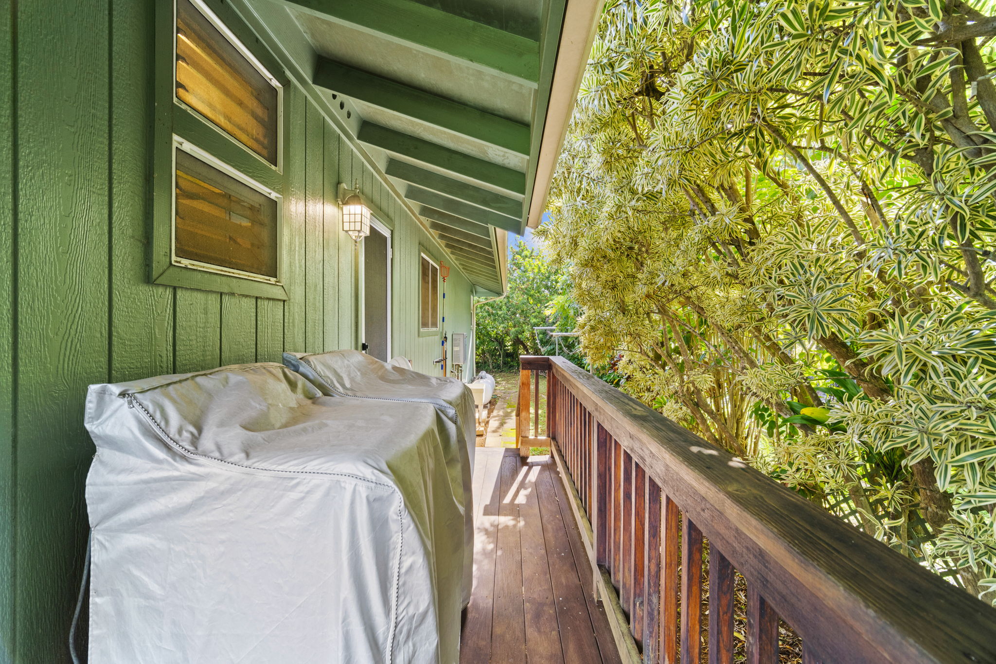 6250 Olohena Road, Unit 2 Kapaa, HI 96746 - Photo 19 of 29 a view of balcony with wooden floor and fence and wooden door