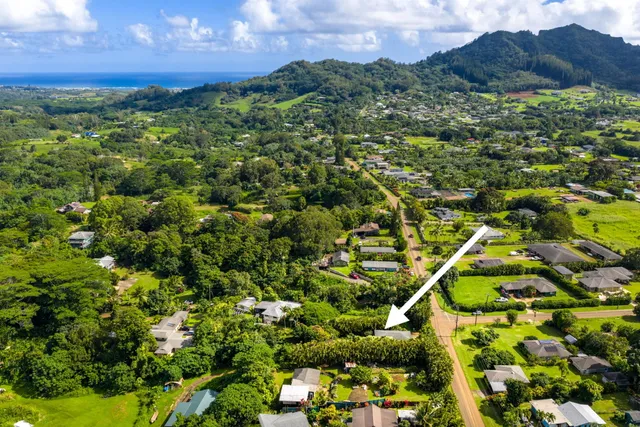 a view of a houses with a lush green hillside