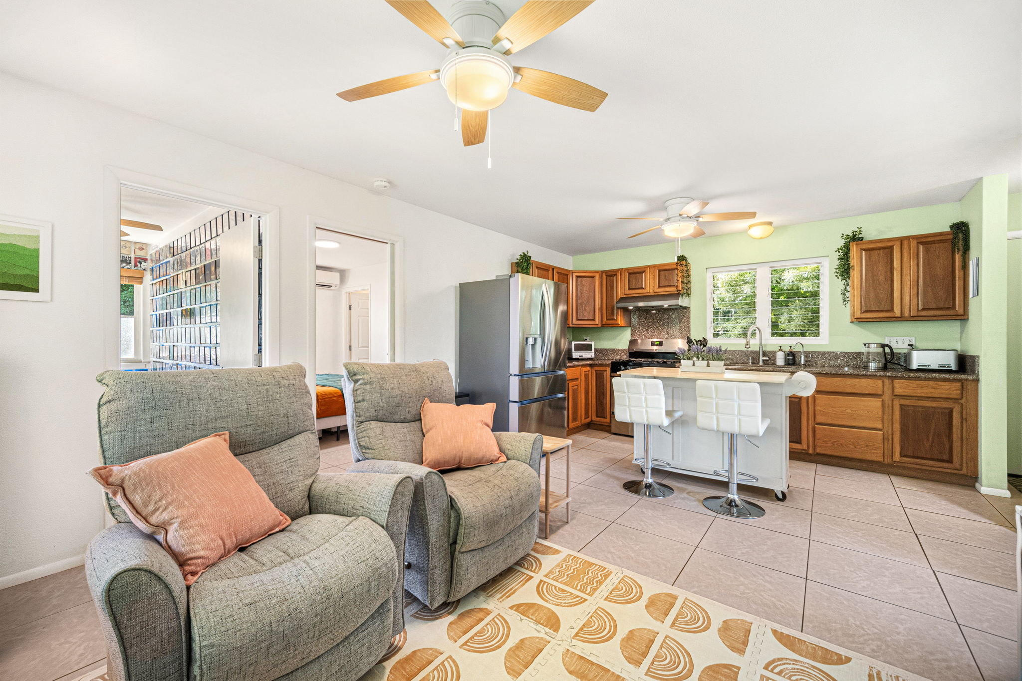 6250 Olohena Road, Unit 2 Kapaa, HI 96746 - Photo 7 of 29 a living room with furniture kitchen view and a chandelier