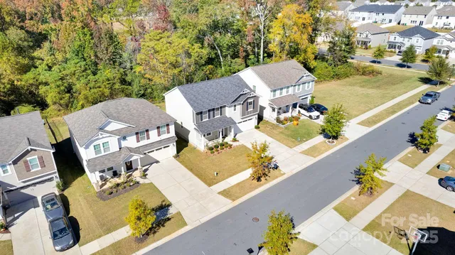an aerial view of a house with a swimming pool