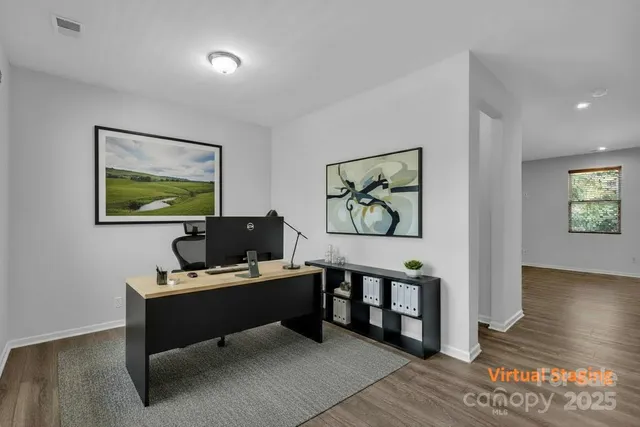 a work room with furniture and wooden floor
