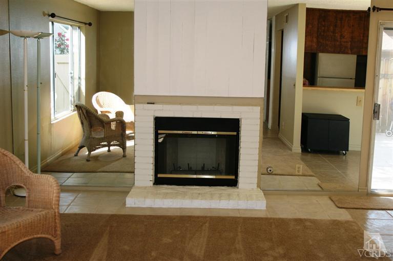 5689 Cochran Street Simi Valley, CA 93063 - Photo 3 of 13 a living room with furniture a fireplace and a flat screen tv