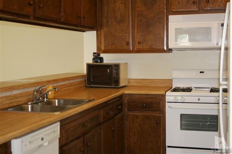 5689 Cochran Street Simi Valley, CA 93063 - Photo 4 of 13 a kitchen with a sink stove and cabinets