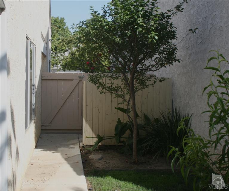 5689 Cochran Street Simi Valley, CA 93063 - Photo 7 of 13 a view of backyard with potted plants and large tree
