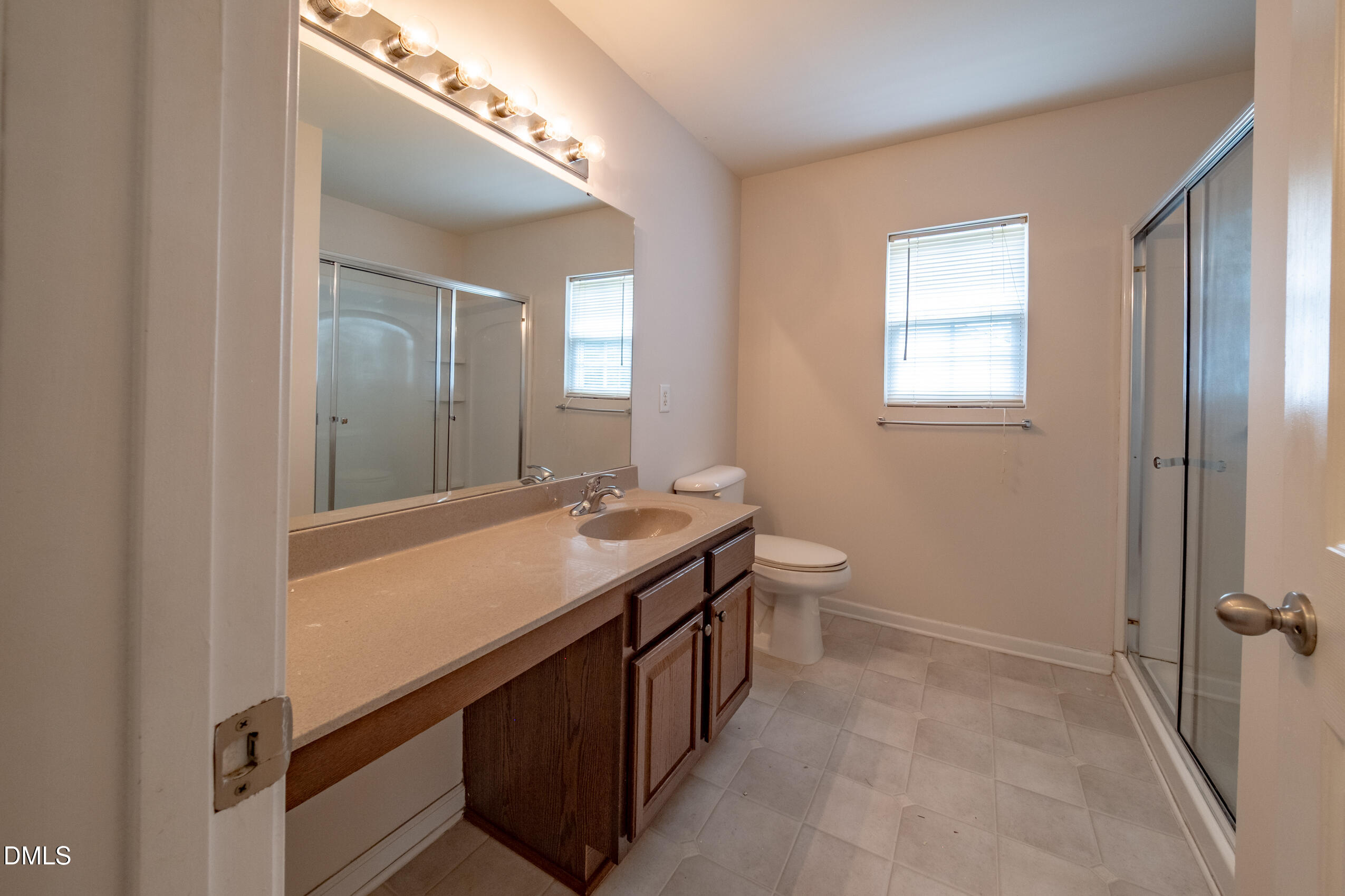 719 Obsidian Way Durham, NC 27703 - Photo 29 of 41 a bathroom with a double vanity sink and a mirror