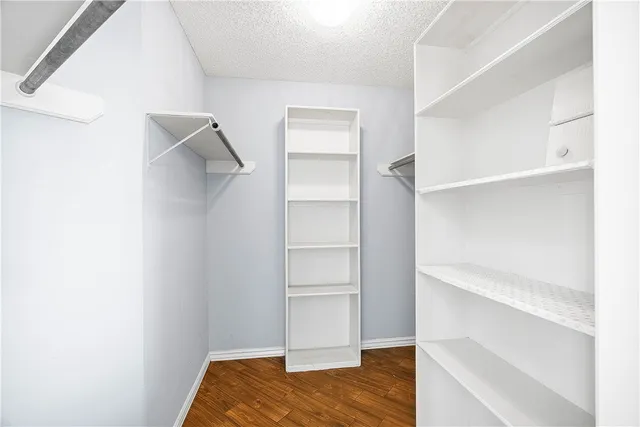 a view of a big room with wooden floor and a ceiling fan