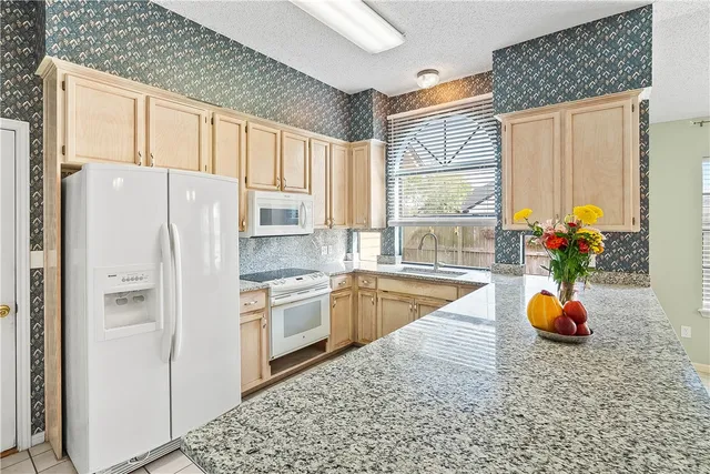 a kitchen with stainless steel appliances a refrigerator sink and cabinets