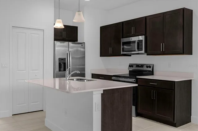 a kitchen with stainless steel appliances granite countertop a sink stove and microwave