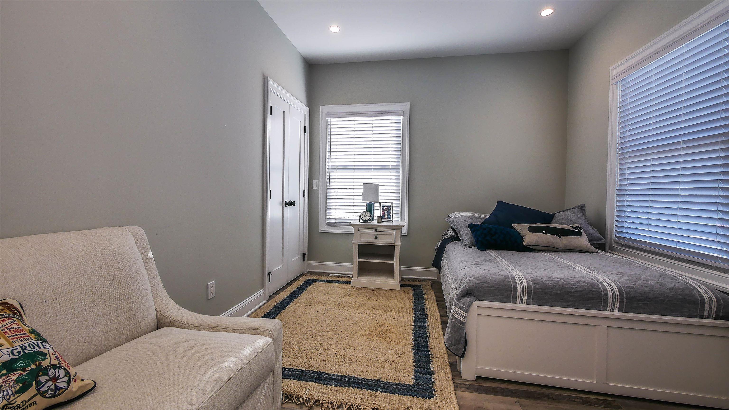 9 Commonwealth Avenue Strathmere, NJ 08248 - Photo 14 of 51 a bedroom with a bed and wooden floor