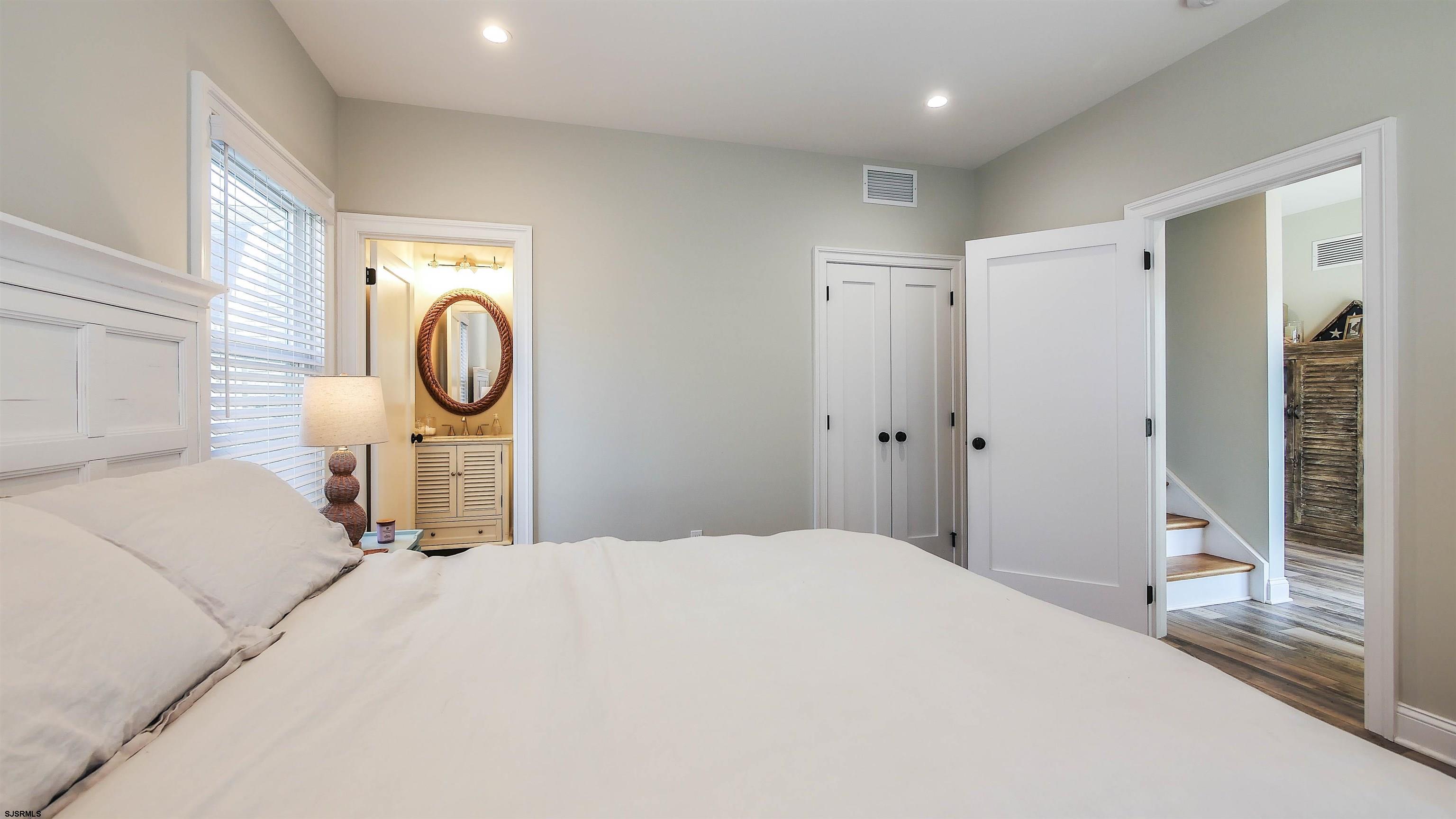 9 Commonwealth Avenue Strathmere, NJ 08248 - Photo 18 of 51 a bedroom with a bed a mirror and shower