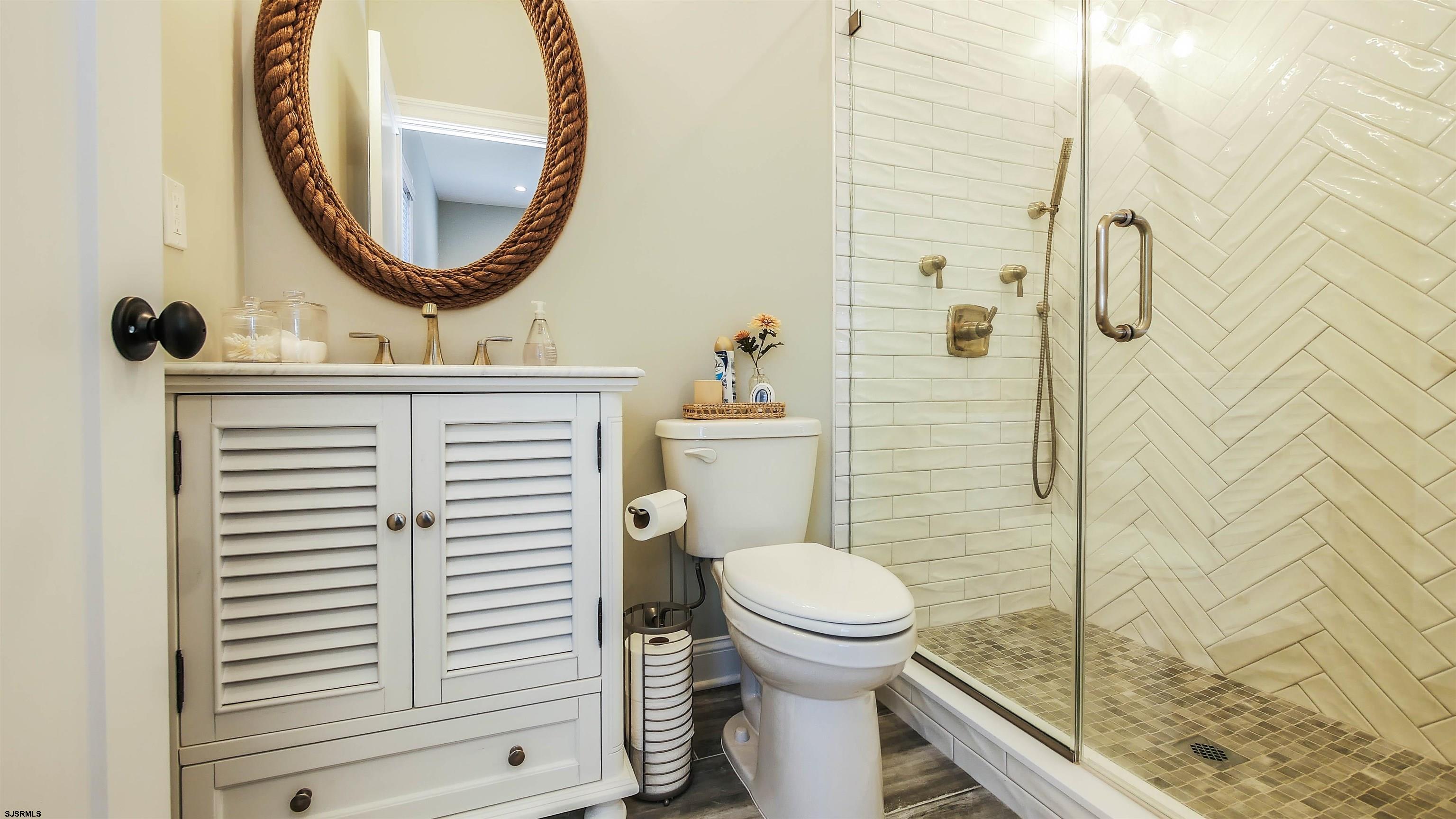 9 Commonwealth Avenue Strathmere, NJ 08248 - Photo 19 of 51 a bathroom with a sink a toilet and a mirror