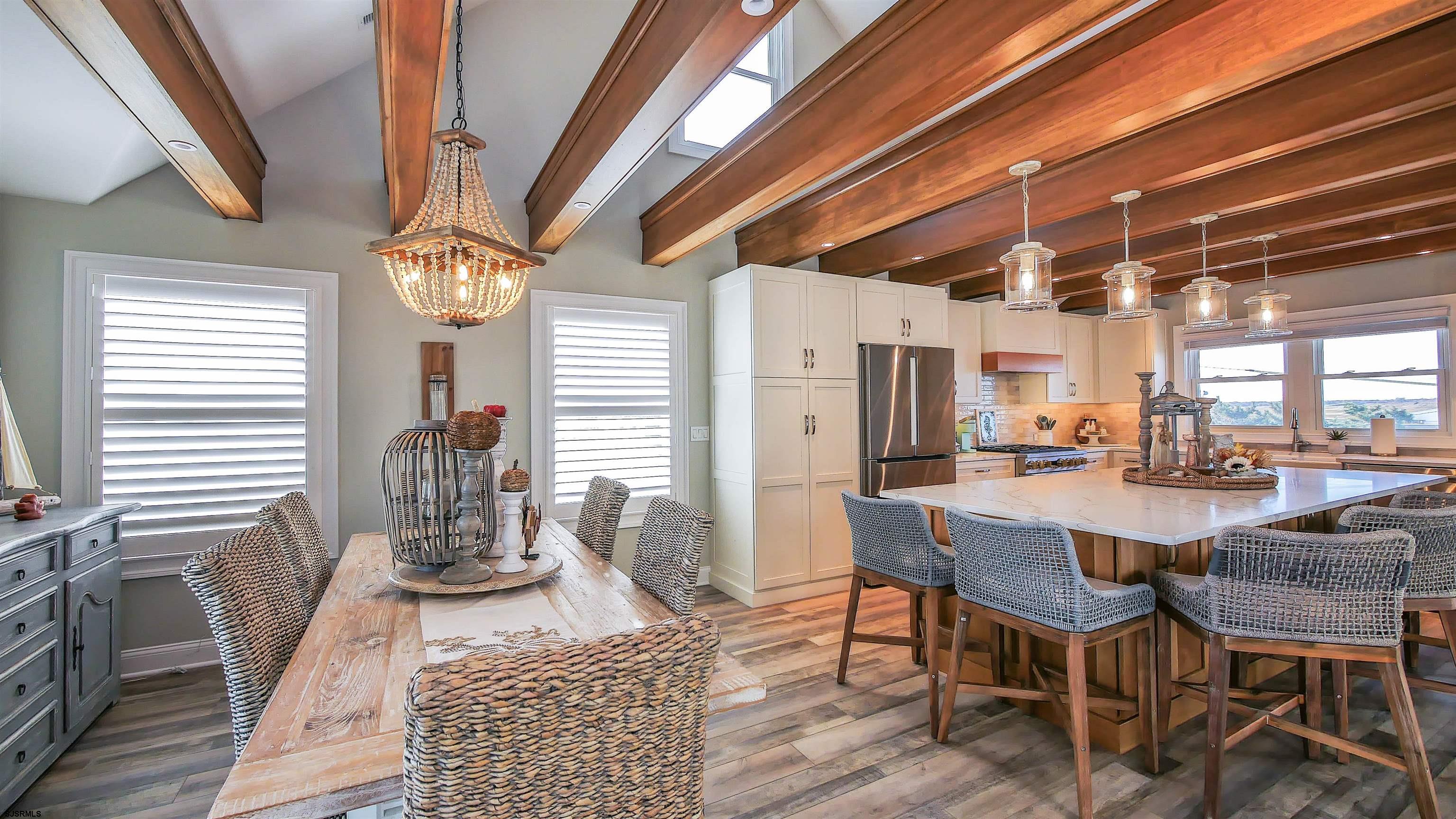 9 Commonwealth Avenue Strathmere, NJ 08248 - Photo 24 of 51 a dining room with furniture a chandelier and wooden floor