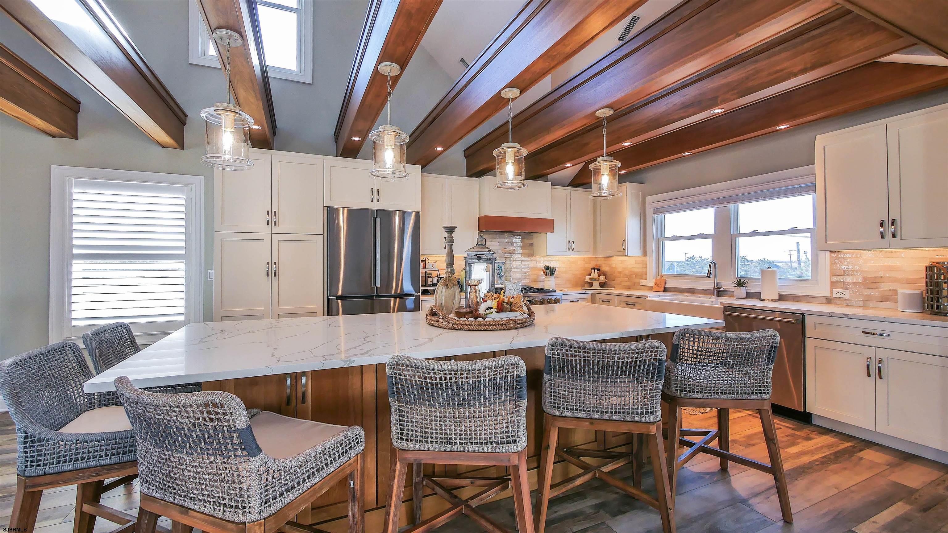 9 Commonwealth Avenue Strathmere, NJ 08248 - Photo 25 of 51 a dining room with furniture a rug and wooden floor