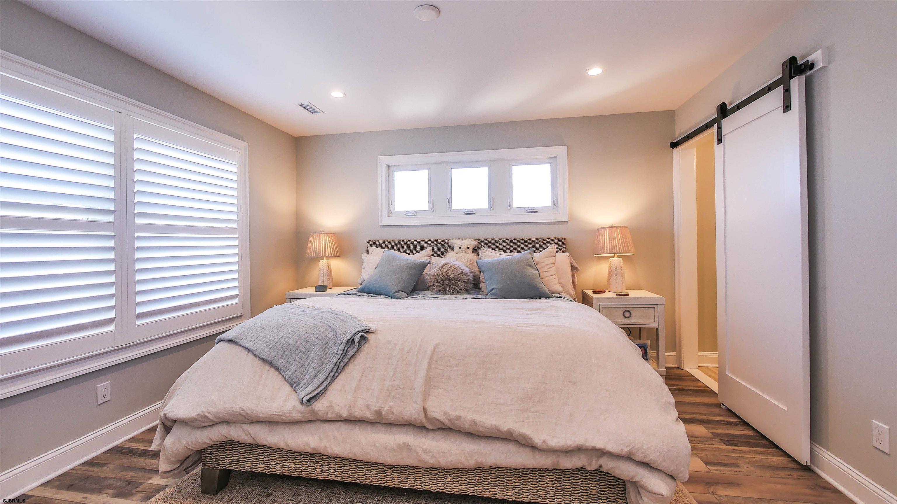 9 Commonwealth Avenue Strathmere, NJ 08248 - Photo 35 of 51 a bedroom with a bed and window