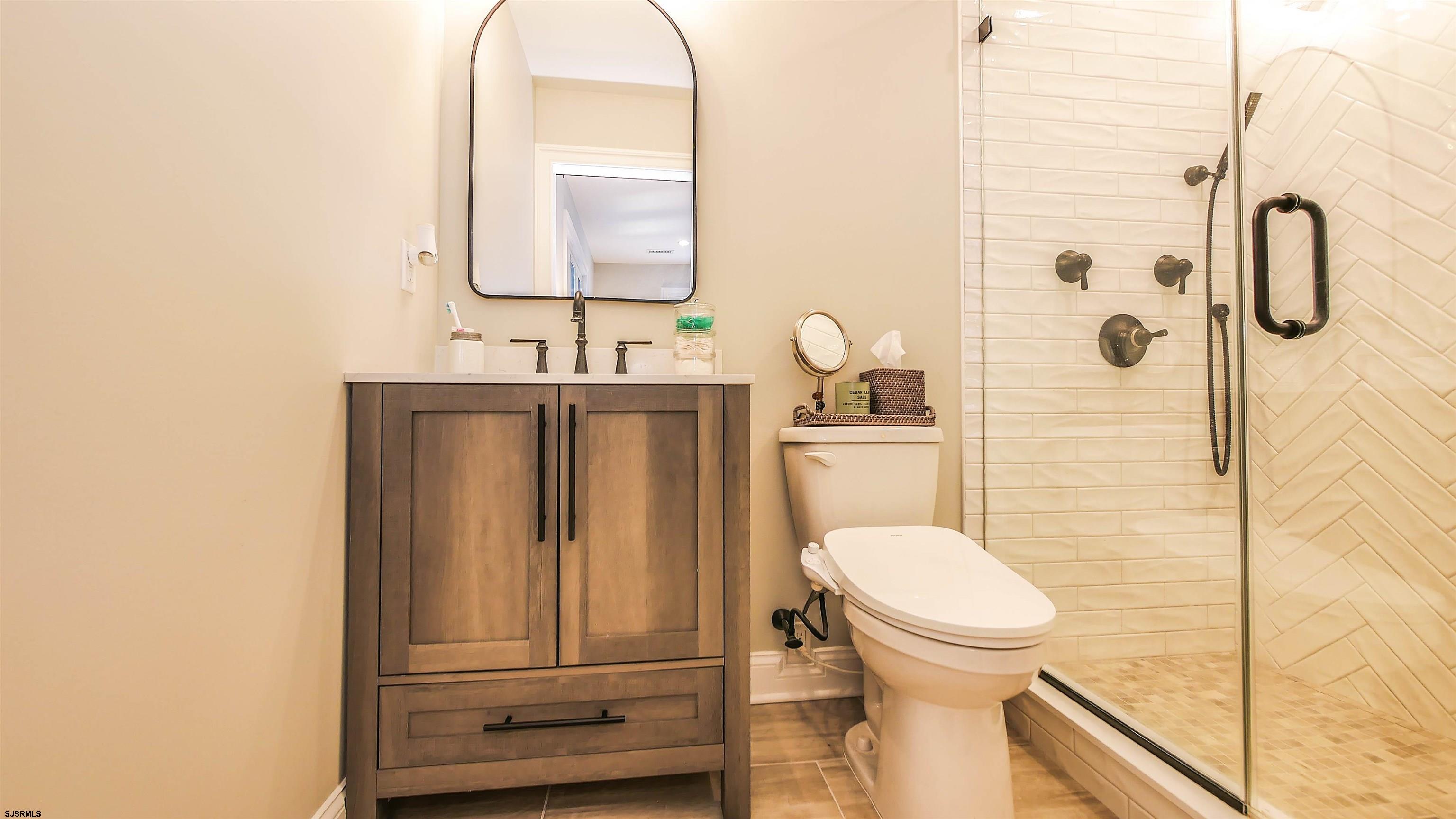 9 Commonwealth Avenue Strathmere, NJ 08248 - Photo 37 of 51 a bathroom with a toilet sink and mirror