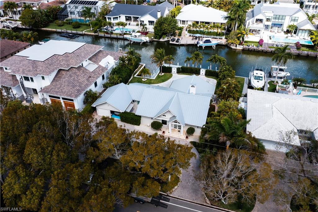 an aerial view of house with yard and lake view
