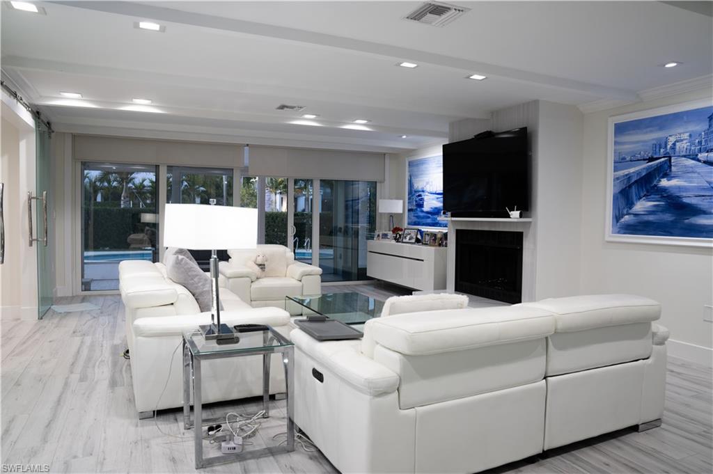 675 18th Avenue South Naples, FL 34102 - Photo 19 of 34 a living room with furniture and a flat screen tv