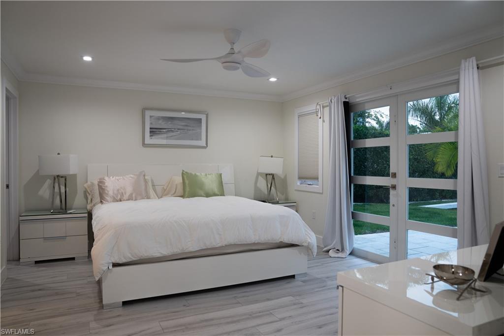 675 18th Avenue South Naples, FL 34102 - Photo 24 of 34 a bedroom with a bed and a large window