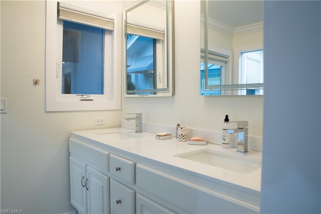 675 18th Avenue South Naples, FL 34102 - Photo 32 of 34 a bathroom with a sink and a mirror