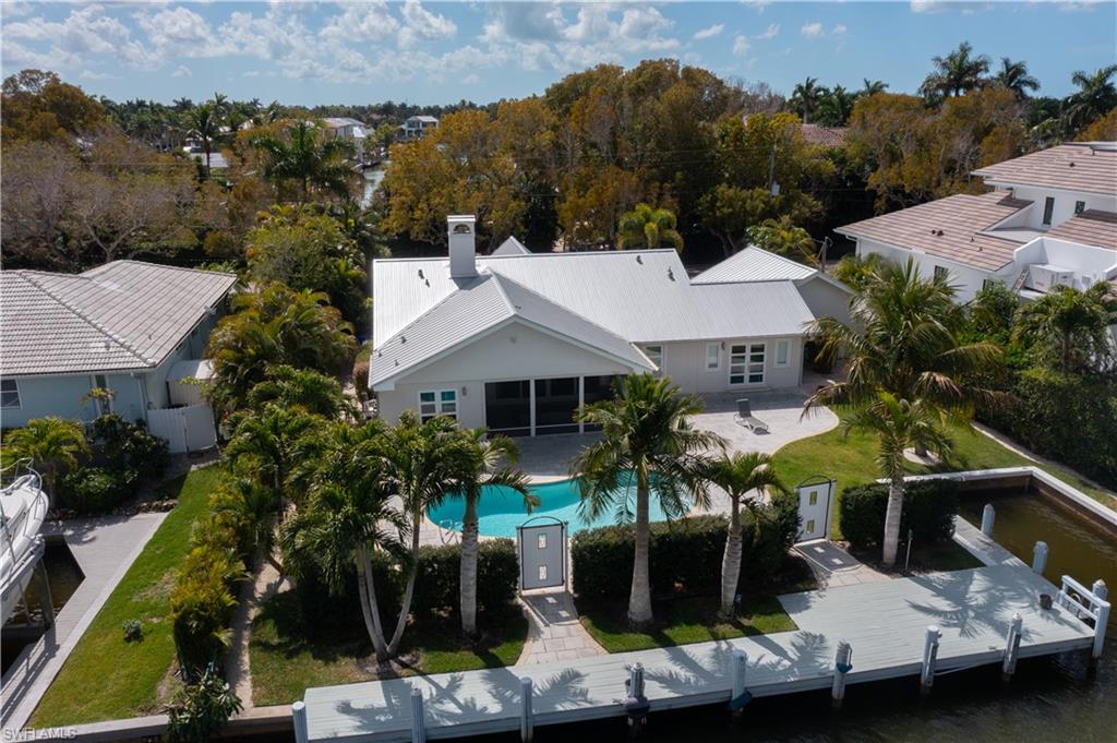 675 18th Avenue South Naples, FL 34102 - Photo 5 of 34 an aerial view of a house with swimming pool and a yard