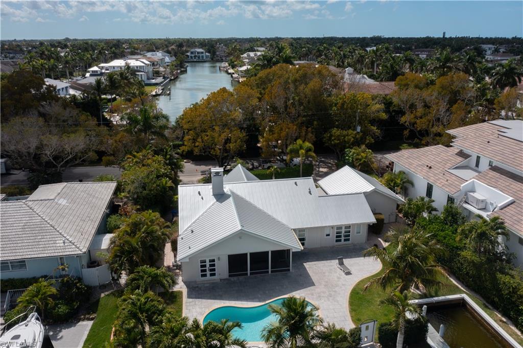 675 18th Avenue South Naples, FL 34102 - Photo 6 of 34 an aerial view of a house with swimming pool and outdoor seating