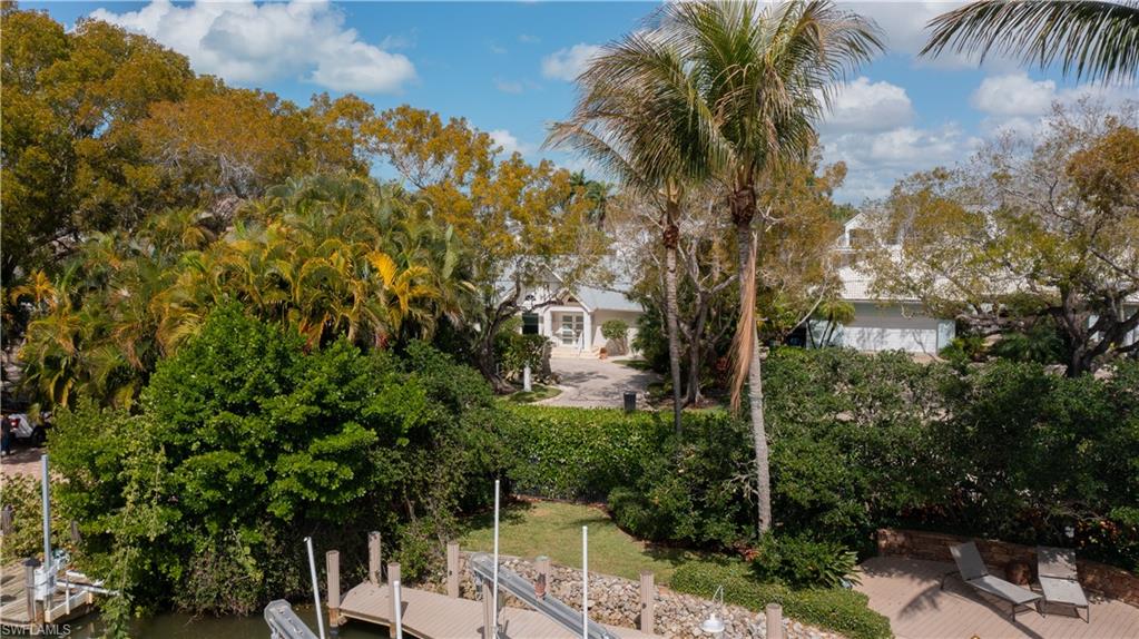 675 18th Avenue South Naples, FL 34102 - Photo 9 of 34 a view of a yard with plants and palm trees