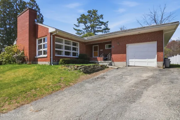 a view of a house with a yard and garage