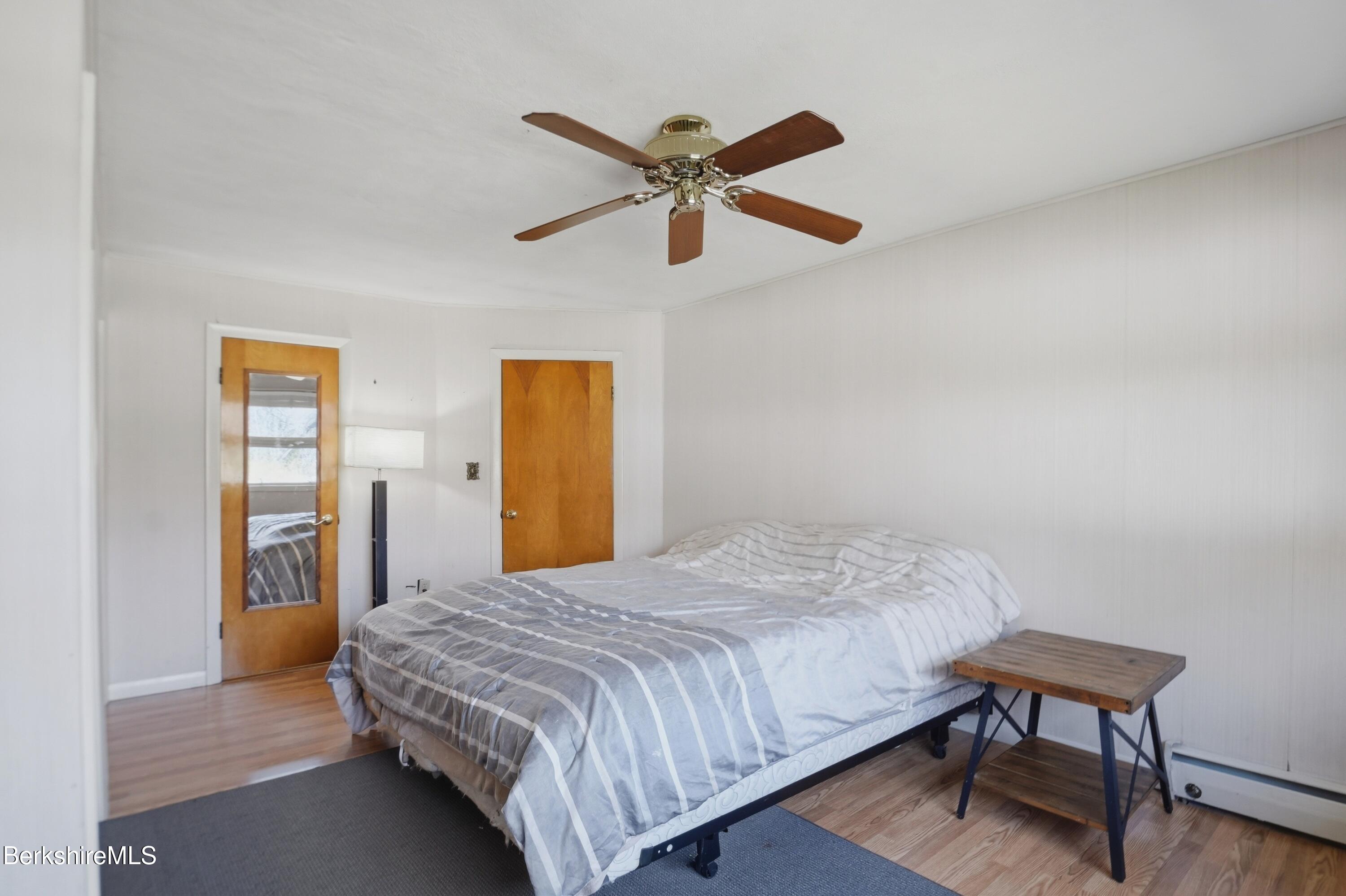 55 Tower Road Dalton, MA 01226 - Photo 15 of 47 a bedroom with a bed and a chandelier