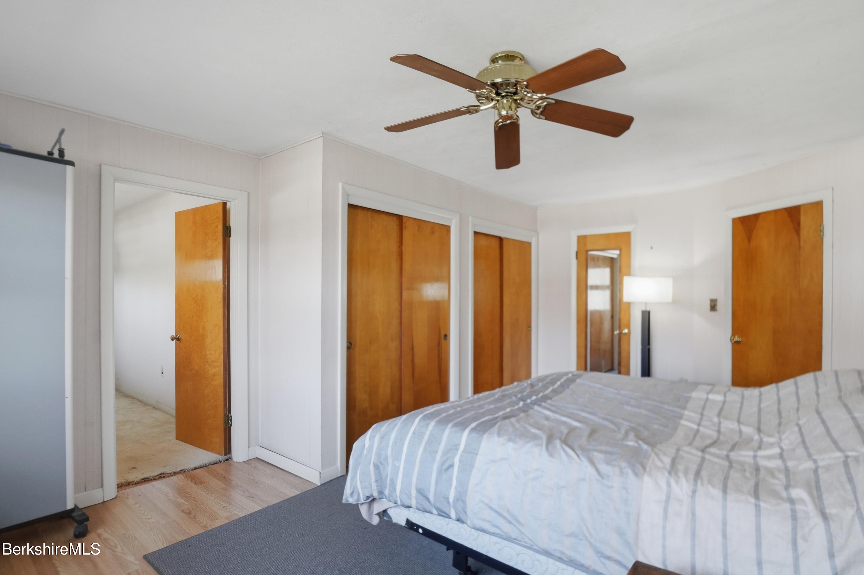 55 Tower Road Dalton, MA 01226 - Photo 16 of 47 a bedroom with a large bed and a chandelier