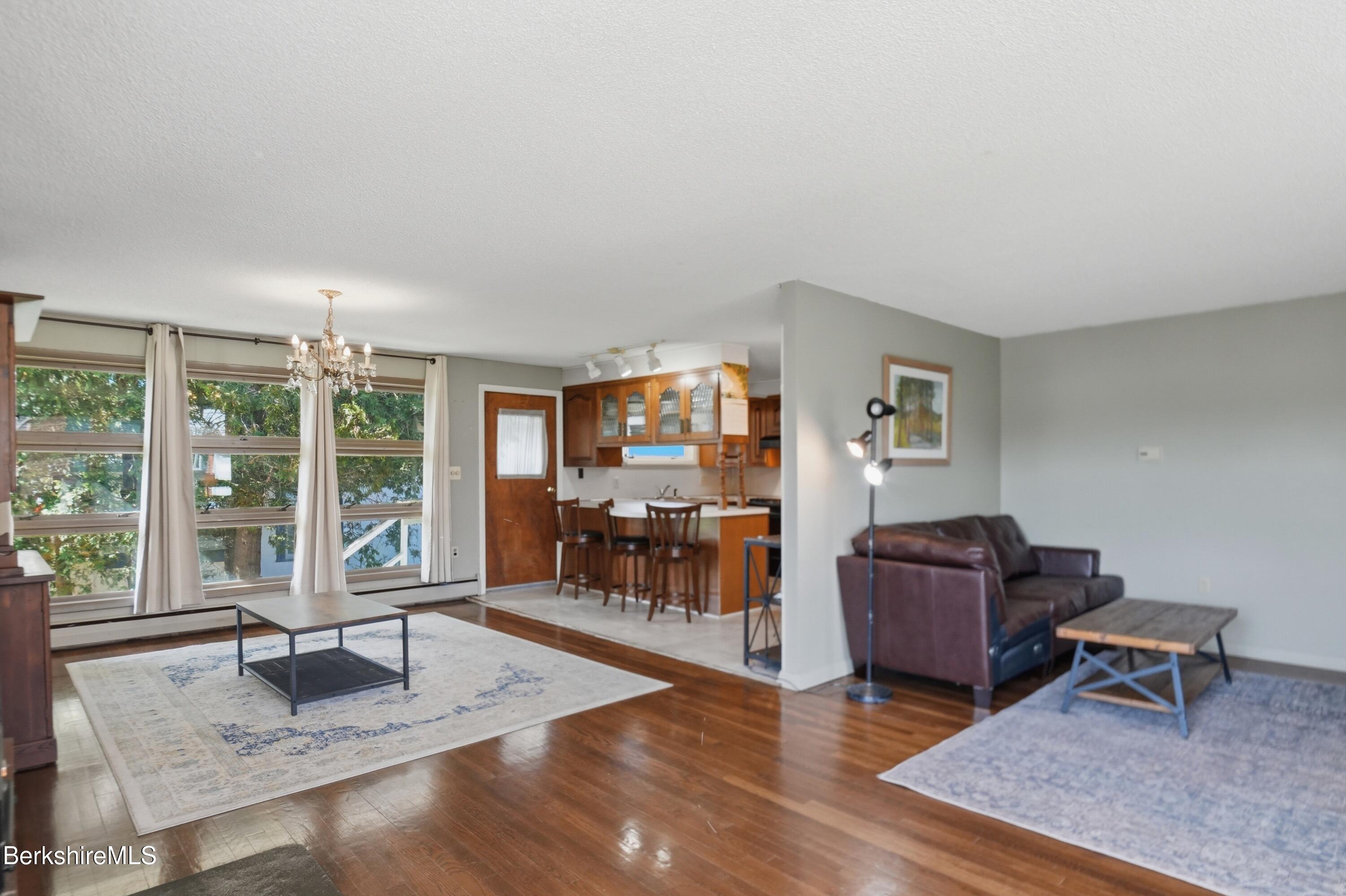 55 Tower Road Dalton, MA 01226 - Photo 2 of 47 a living room with furniture a flat screen tv and a large window