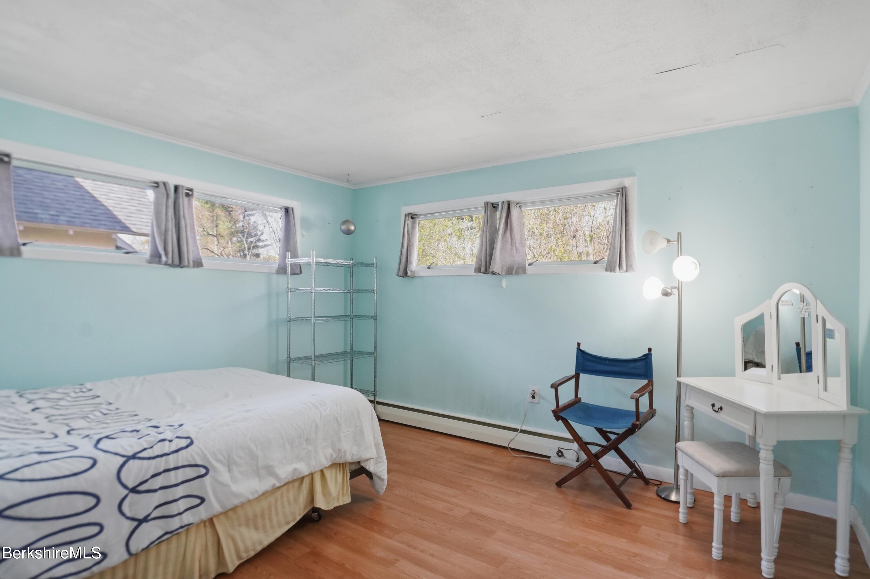 55 Tower Road Dalton, MA 01226 - Photo 21 of 47 a bedroom with a bed a chair and painting on the wall